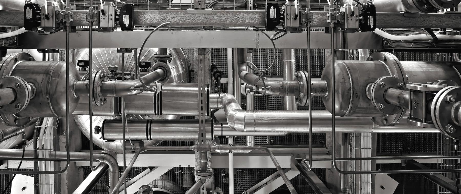 Close-up of stainless steel process piping and valves