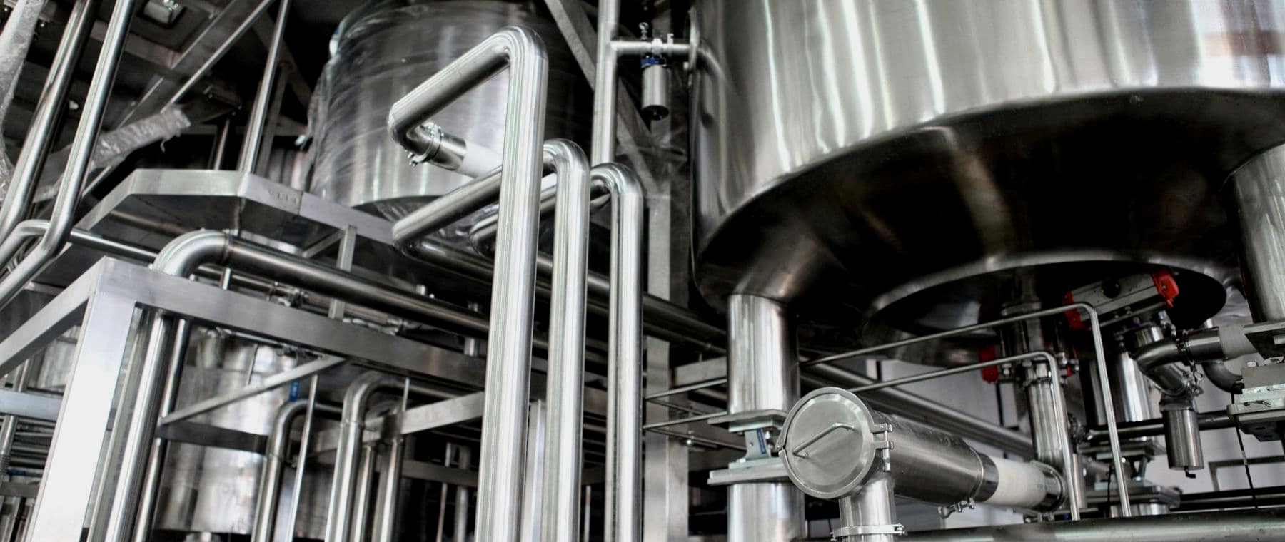 Close-up of stainless steel processing vessels and pipework